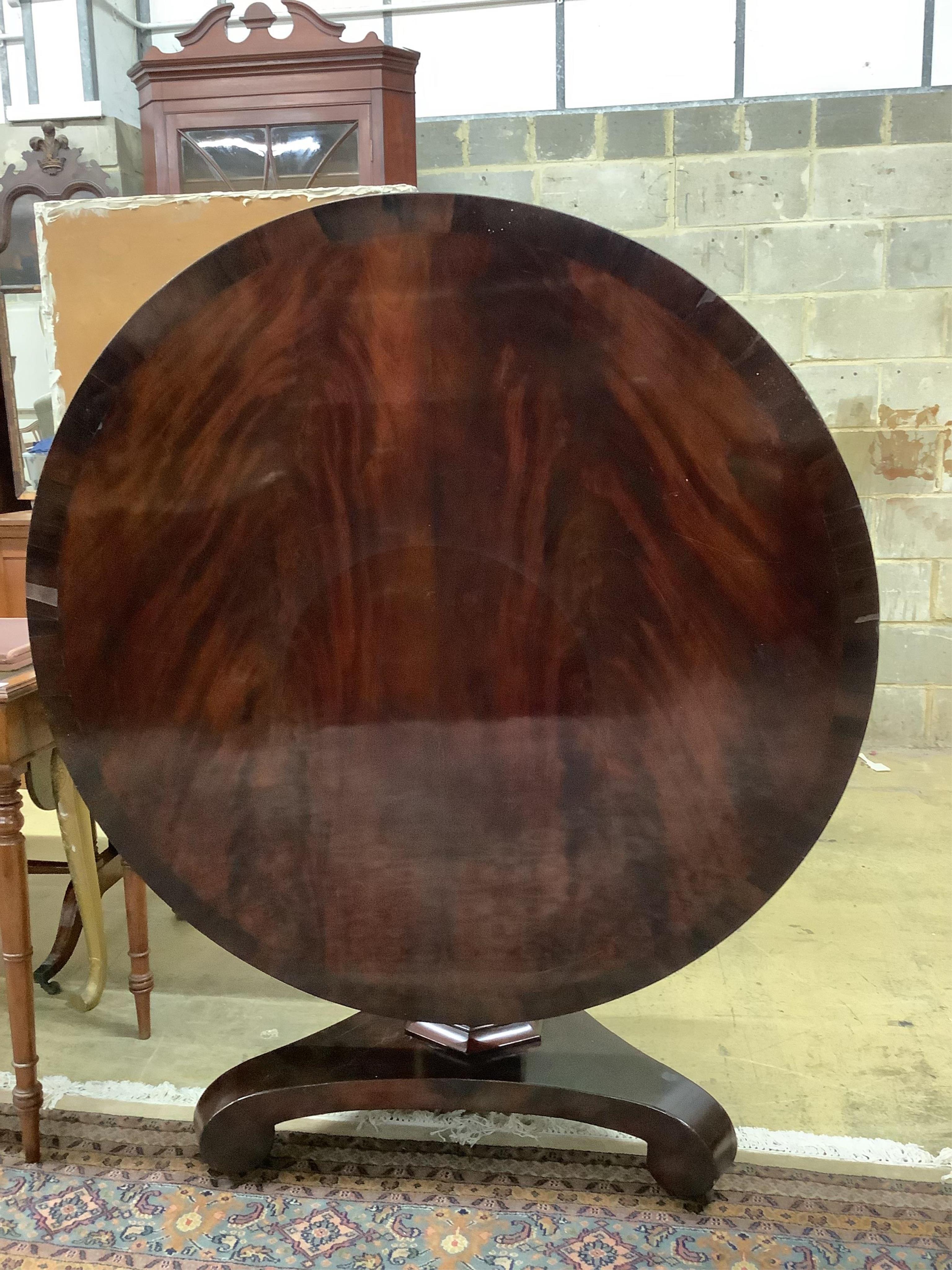 An early Victorian mahogany tilt top breakfast table, diameter 124cm, height 72cm. Condition poor to fair.